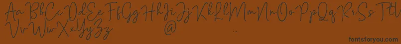 Mention Signature Font – Black Fonts on Brown Background