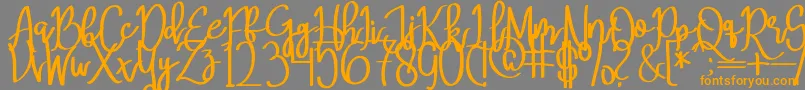 フォントMeryQolbyRegular – オレンジの文字は灰色の背景にあります。