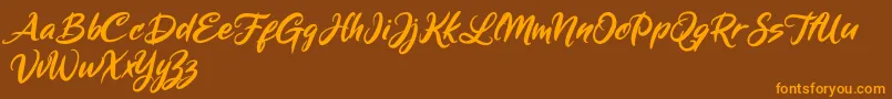 Weitere Informationen zur Mickey Steward-Schriftart Mickey Steward-Schriftart – Orangefarbene Schriften auf braunem Hintergrund