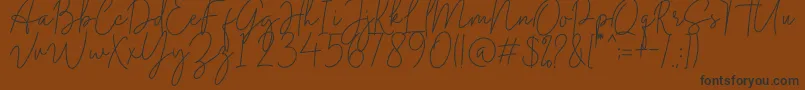 フォントMidnight Signature – 黒い文字が茶色の背景にあります