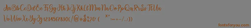 フォントmigdale – 茶色の文字が灰色の背景にあります。