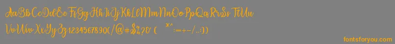 フォントmigdale – オレンジの文字は灰色の背景にあります。