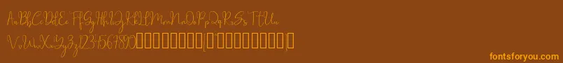 フォントmillow – オレンジ色の文字が茶色の背景にあります。