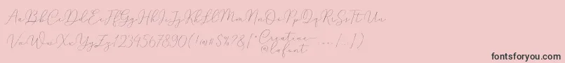 Fonte Mindline Script Demo – fontes pretas em um fundo rosa