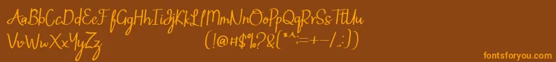 フォントMintlic – オレンジ色の文字が茶色の背景にあります。