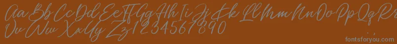 Miss Catlyne-Schriftart – Graue Schriften auf braunem Hintergrund