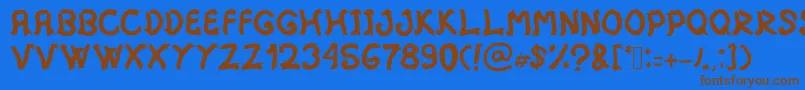 フォントMistica – 茶色の文字が青い背景にあります。