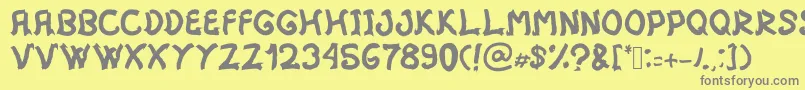 フォントMistica – 黄色の背景に灰色の文字