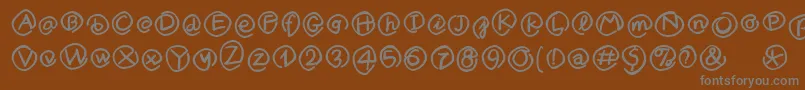 MKlammerAffen-fontti – harmaat kirjasimet ruskealla taustalla