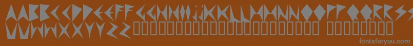 MNDPF   -fontti – harmaat kirjasimet ruskealla taustalla