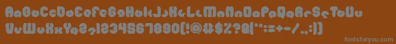 MOHR Bold-fontti – harmaat kirjasimet ruskealla taustalla
