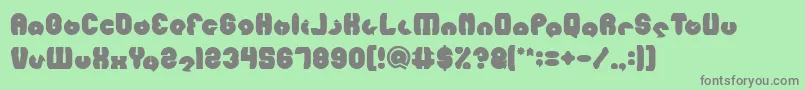 MOHR Bold-fontti – harmaat kirjasimet vihreällä taustalla