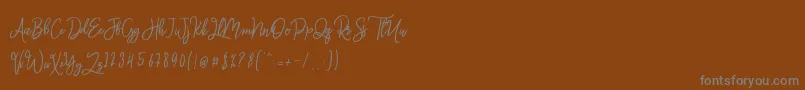 フォントMonalisa Script – 茶色の背景に灰色の文字
