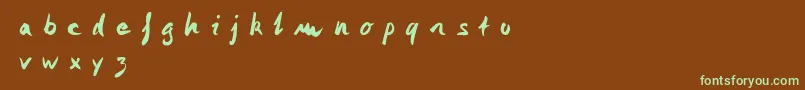 フォントMonika Monika – 緑色の文字が茶色の背景にあります。
