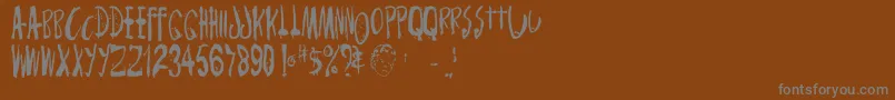 Monsterchild-fontti – harmaat kirjasimet ruskealla taustalla