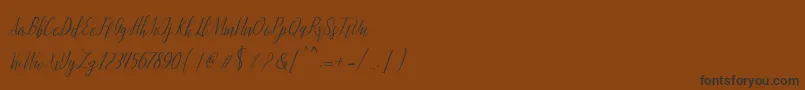 フォントmontalia script – 黒い文字が茶色の背景にあります