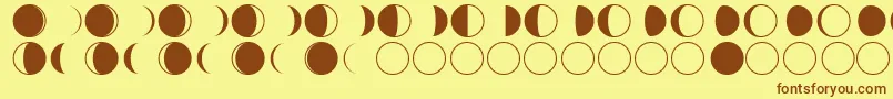 フォントmoon phases – 茶色の文字が黄色の背景にあります。