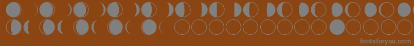 moon phases-fontti – harmaat kirjasimet ruskealla taustalla