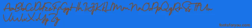 フォントMorning Gold Free – 茶色の文字が青い背景にあります。