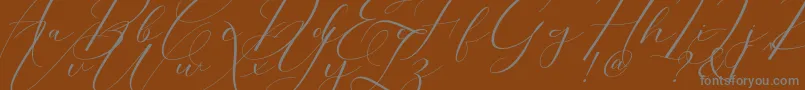 Morris Script-Schriftart – Graue Schriften auf braunem Hintergrund