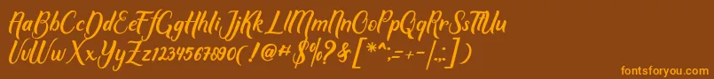 フォントMother love – オレンジ色の文字が茶色の背景にあります。