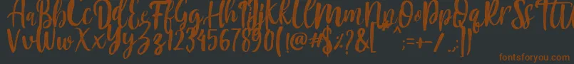 フォントMountain Script   Brush Font – 黒い背景に茶色のフォント