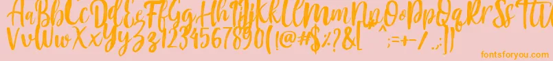 フォントMountain Script   Brush Font – オレンジの文字がピンクの背景にあります。