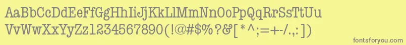 ItcAmericanTypewriterMediumCondensed-fontti – harmaat kirjasimet keltaisella taustalla