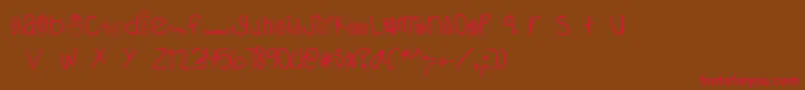 フォントMTFDearSanta – 赤い文字が茶色の背景にあります。