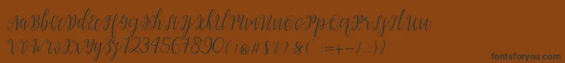 Czcionka My Darling Script  – czarne czcionki na brązowym tle