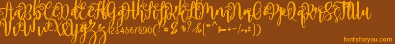 フォントmyhope – オレンジ色の文字が茶色の背景にあります。