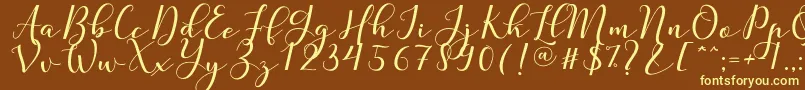 Nafigat Script Font – Yellow Fonts on Brown Background