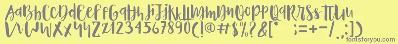 Naira-fontti – harmaat kirjasimet keltaisella taustalla