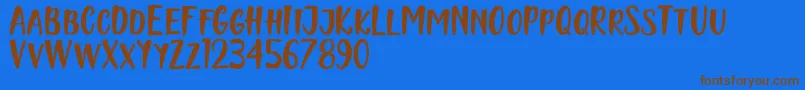Naishila Caps Font – Brown Fonts on Blue Background