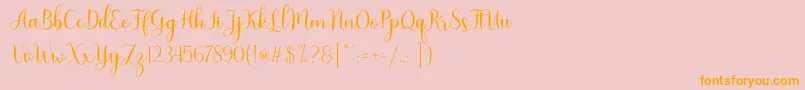 フォントNattalia – オレンジの文字がピンクの背景にあります。