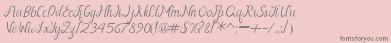 Nayla Free-fontti – harmaat kirjasimet vaaleanpunaisella taustalla
