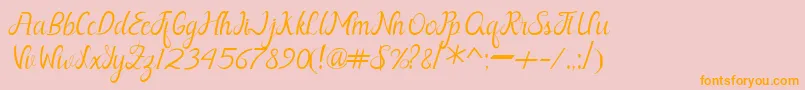 フォントNayla Free – オレンジの文字がピンクの背景にあります。