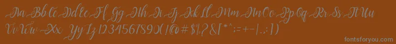 Czcionka Nayla Script – szare czcionki na brązowym tle