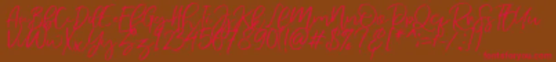 NermolaScript Regular Font – Red Fonts on Brown Background