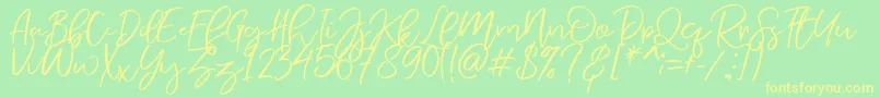 Fonte NermolaScript Regular – fontes amarelas em um fundo verde