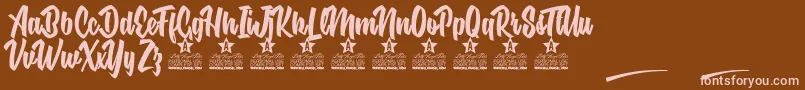 フォントNuclear Boots Personal Use – 茶色の背景にピンクのフォント