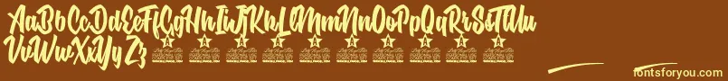 フォントNuclear Boots Personal Use – 黄色のフォント、茶色の背景