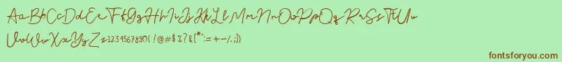 Nusapenida Signature Font – Brown Fonts on Green Background