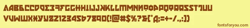 フォントnyetcond – 茶色の文字が黄色の背景にあります。