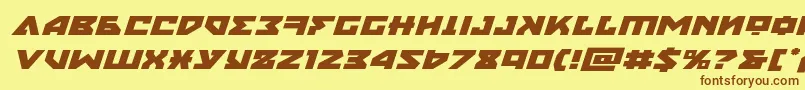 フォントnyetexpandital – 茶色の文字が黄色の背景にあります。