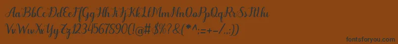 フォントOdelette – 黒い文字が茶色の背景にあります