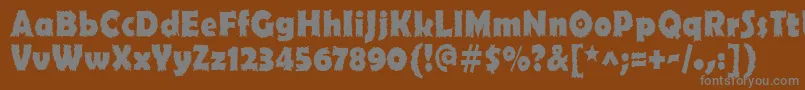 Ojovanic Bold-fontti – harmaat kirjasimet ruskealla taustalla