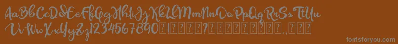 フォントOlcigatte DEMO – 茶色の背景に灰色の文字