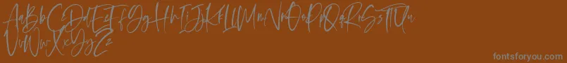 Oliver Notes-Schriftart – Graue Schriften auf braunem Hintergrund