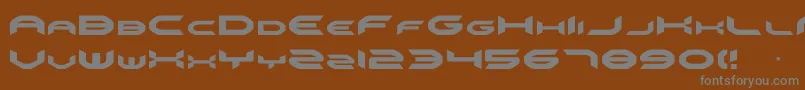 omnigirl-fontti – harmaat kirjasimet ruskealla taustalla